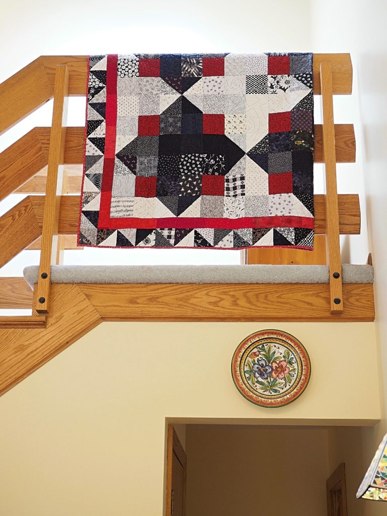 Save money and use the railings around your house to display quilts.