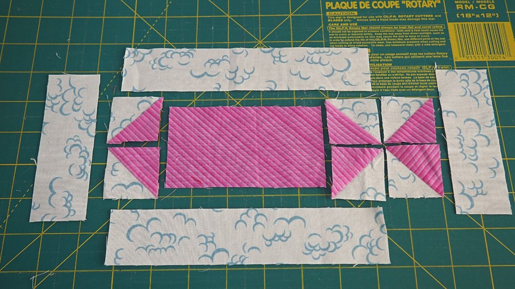 Laying out the scrappy swimming fish quilt block